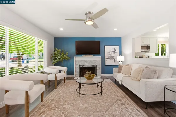 a living room with furniture a fireplace and a flat screen tv