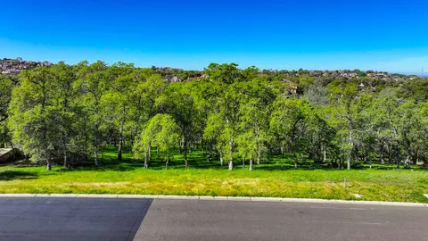 a view of backyard with swimming pool and outdoor seating