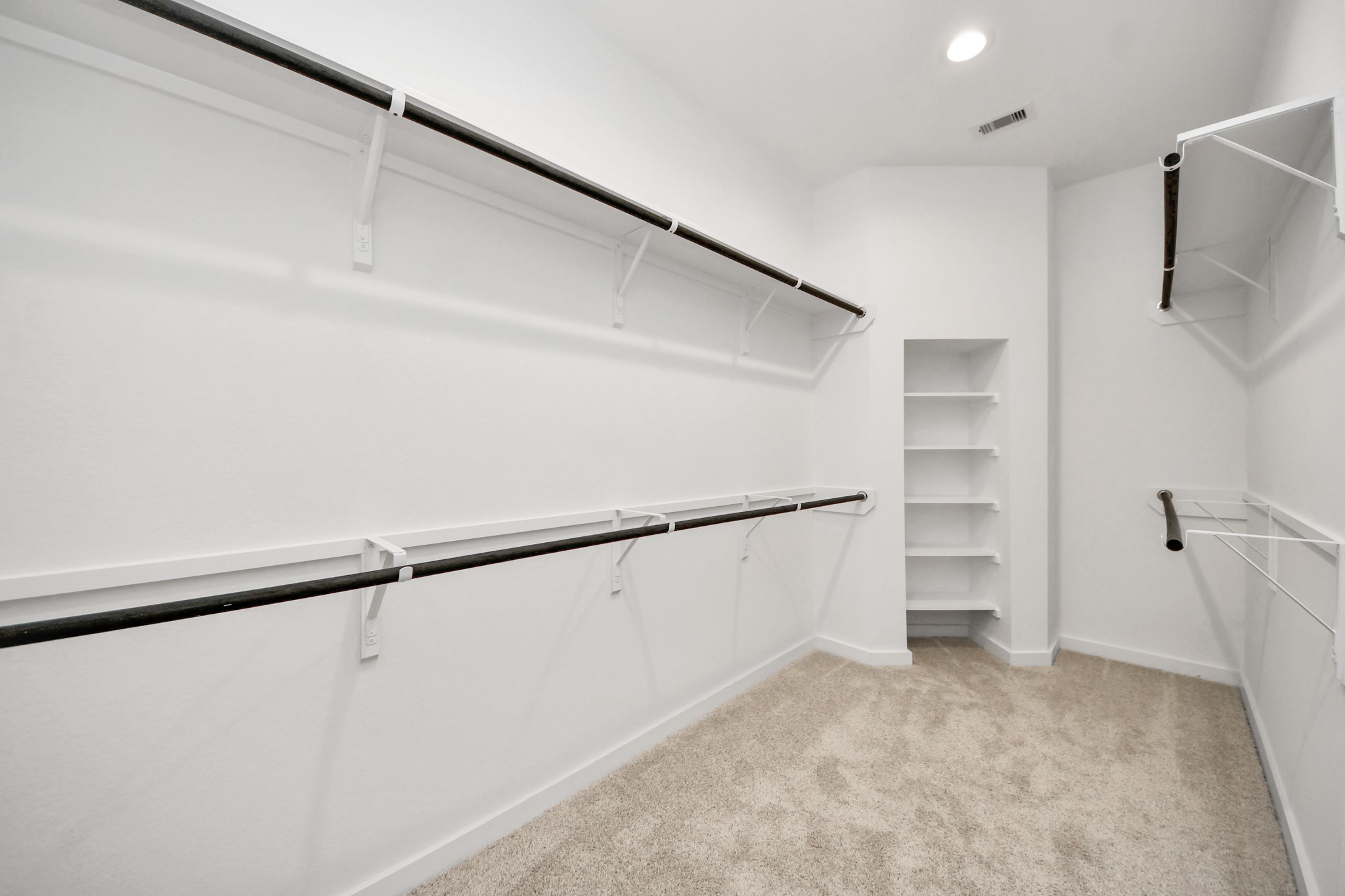 24519 Broad Park Spring, TX 77373 - Photo 25 of 36 Walk-in closet that epitomizes luxury and practicality. This generously sized space features built-in shelving, offering abundant room for impeccable organization. High ceilings and recessed lighting create a bright and welcoming ambiance. Sample photo of completed home with similar floor plan. Actual colors and selections may vary.