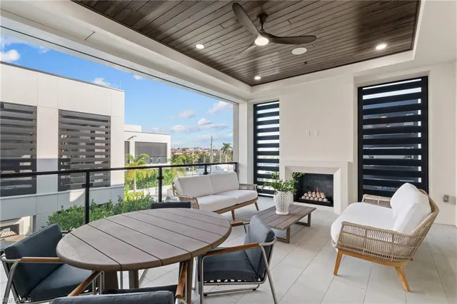 a outdoor space with patio the couches and a fireplace