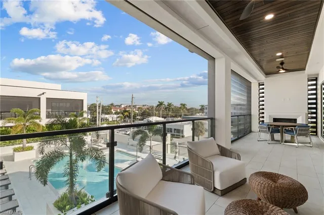 a view of a balcony with couches and wooden floor