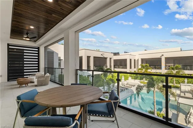 a balcony with table and chairs