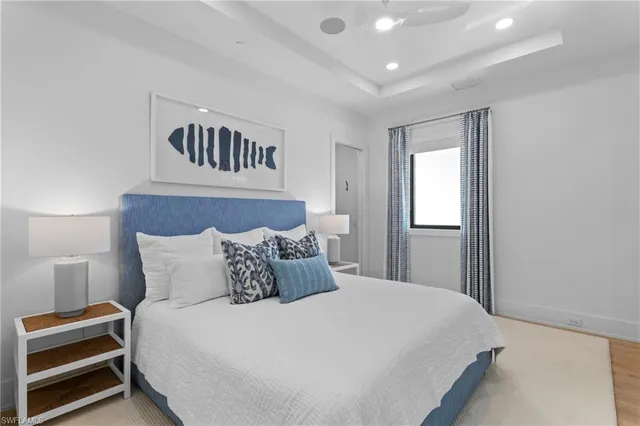 a bedroom with a bed and a night stand