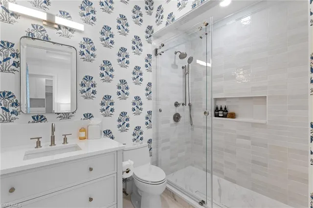 a bathroom with a sink toilet and shower