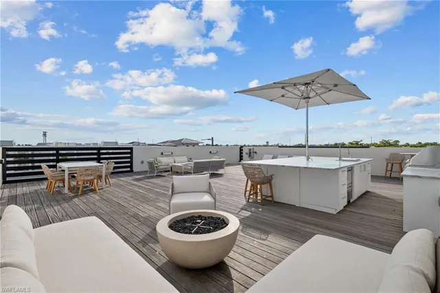 a view of a terrace with furniture and sky view