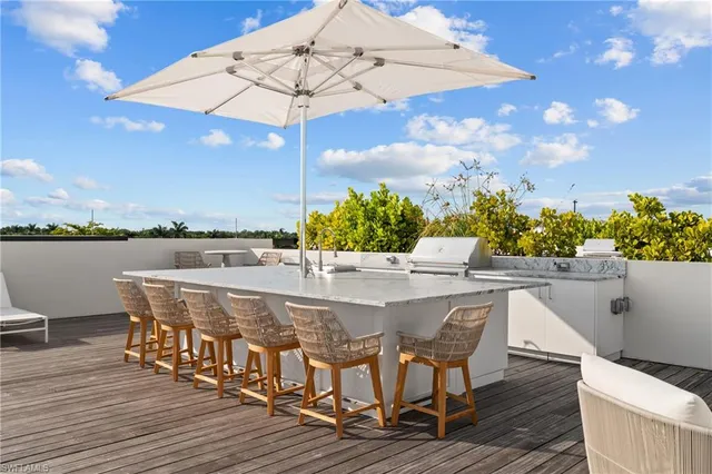 a view of a chairs and table on the wooden deck