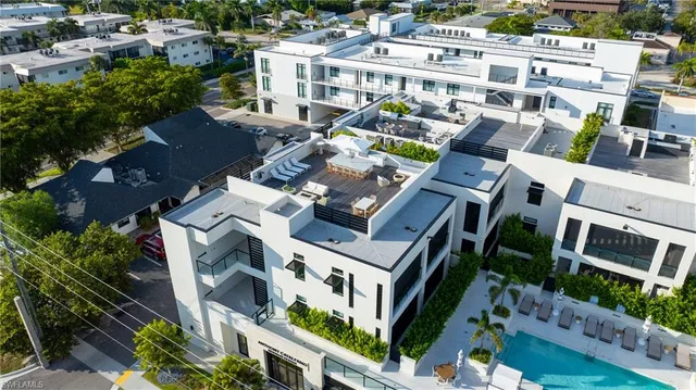 an aerial view of multiple houses with yard