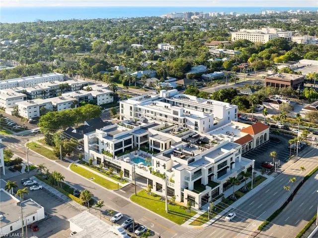 a view of a patio with couches table and chairs and potted plants