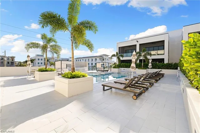a view of a patio with dining table and chairs with plants