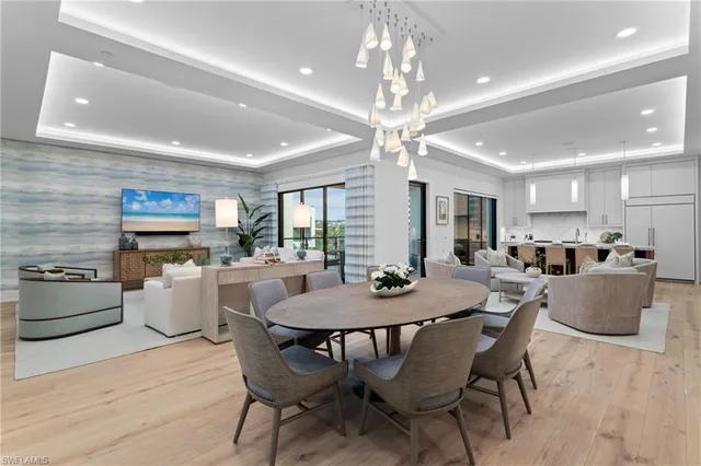 a view of a dining room with furniture and a chandelier