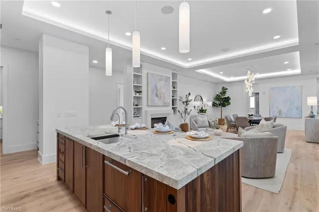 a kitchen with granite countertop a sink and white cabinets