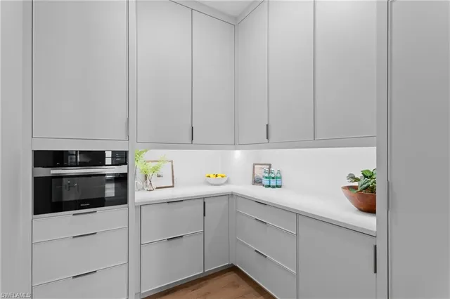 a kitchen with white cabinets and white appliances