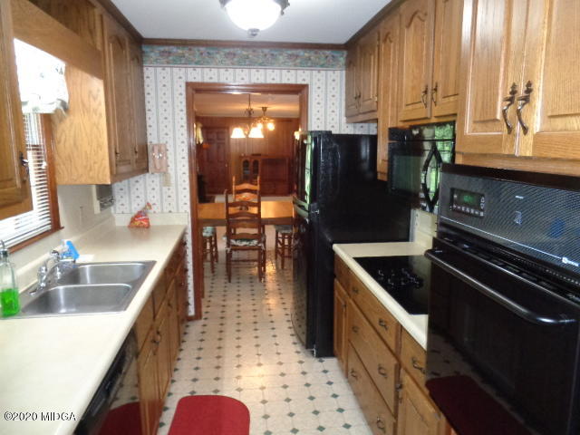5539 Bankston Lake Road Macon, GA 31216 - Photo 11 of 29 a kitchen with granite countertop a stove a sink and a microwave
