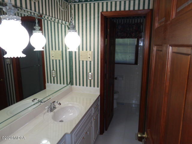 5539 Bankston Lake Road Macon, GA 31216 - Photo 18 of 29 a bathroom with a sink and mirror