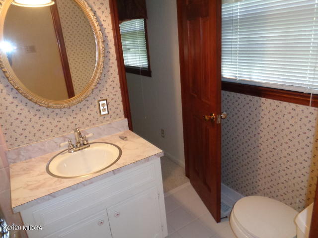 5539 Bankston Lake Road Macon, GA 31216 - Photo 23 of 29 a bathroom with a sink mirror vanity and toilet