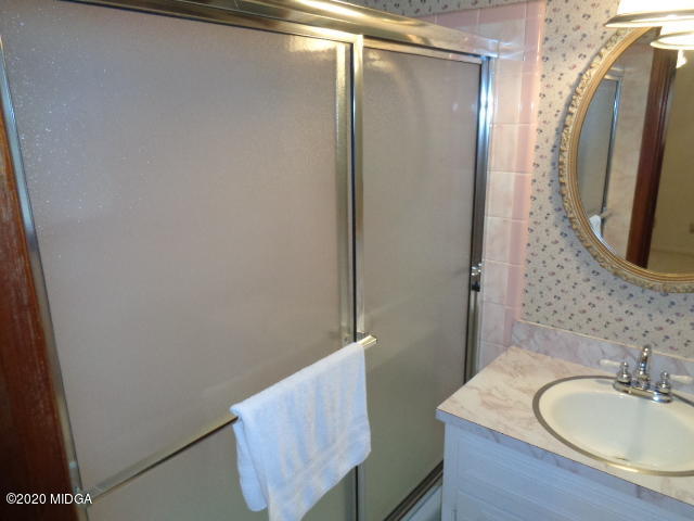 5539 Bankston Lake Road Macon, GA 31216 - Photo 24 of 29 a bathroom with a sink and a mirror