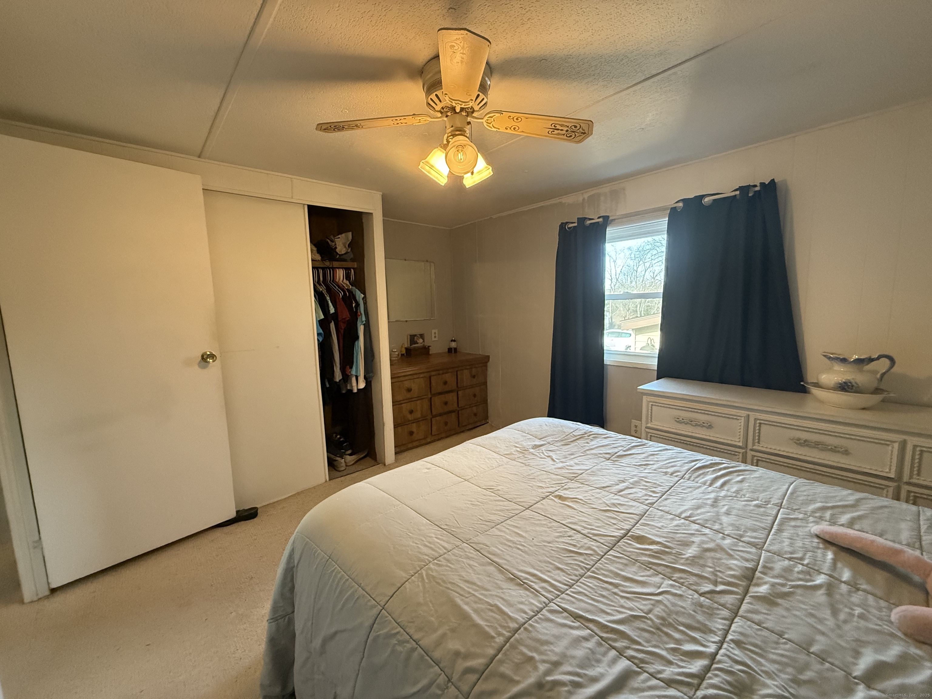 4 Sunshine Terrace Thompson, CT 06255 - Photo 16 of 25 a bedroom with a large bed and a chandelier