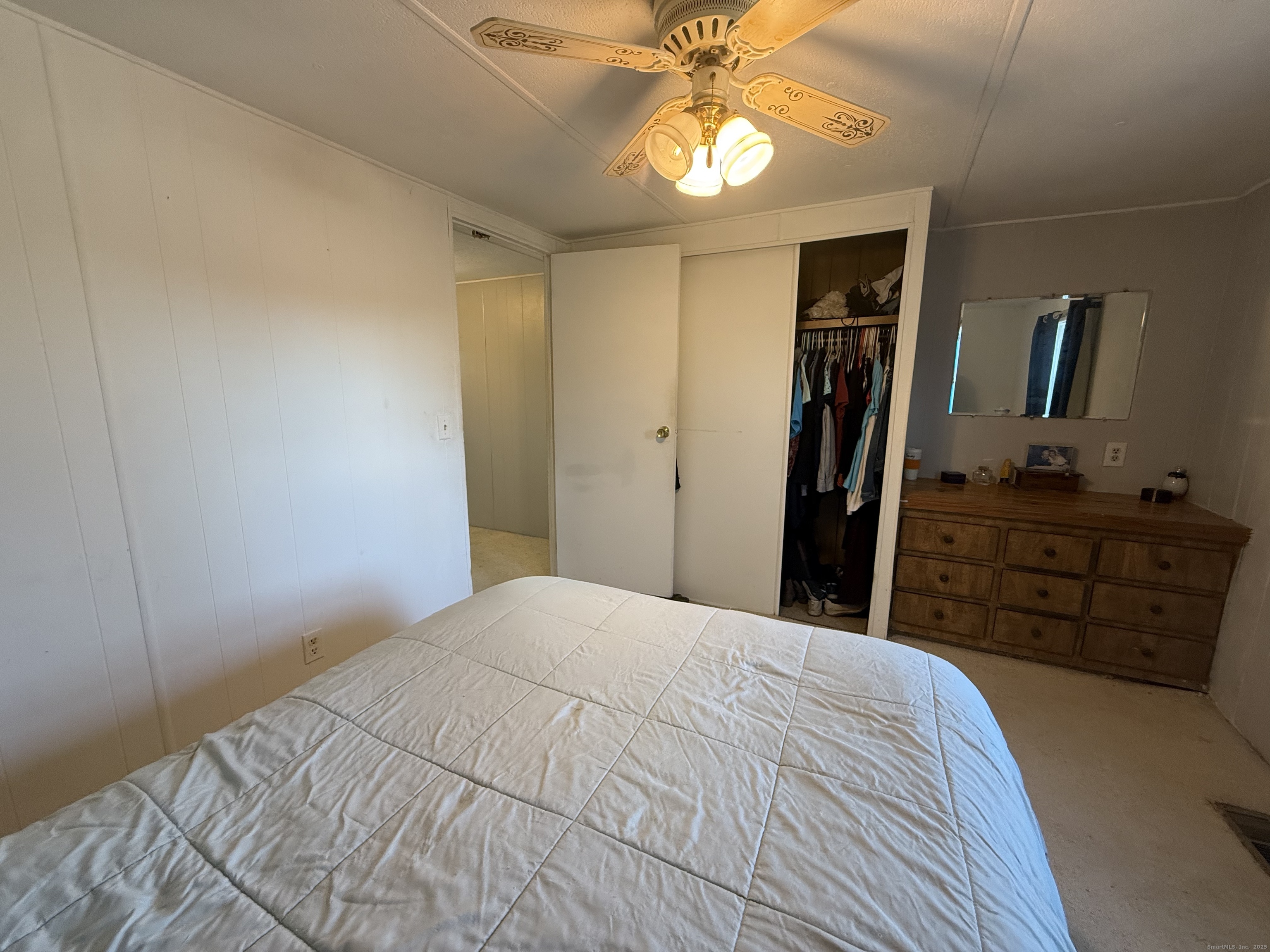 4 Sunshine Terrace Thompson, CT 06255 - Photo 17 of 25 a bedroom with a bed and a chandelier