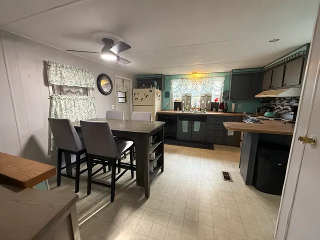 a kitchen with a table chairs and a refrigerator