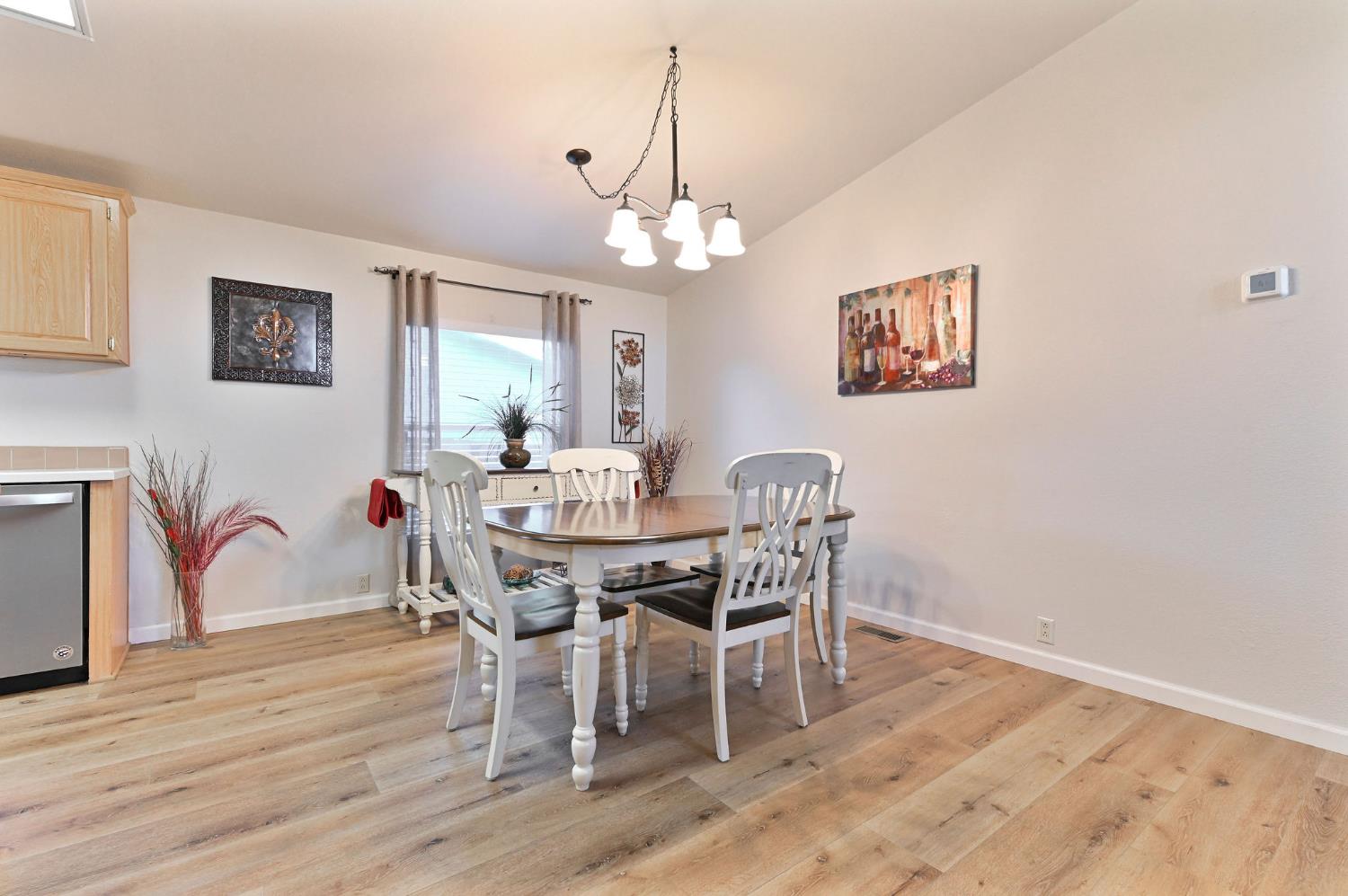 1400 West Marlette Street, Unit 2 Ione, CA 95640 - Photo 14 of 79 a view of a dining room with furniture wooden floor and a chandelier
