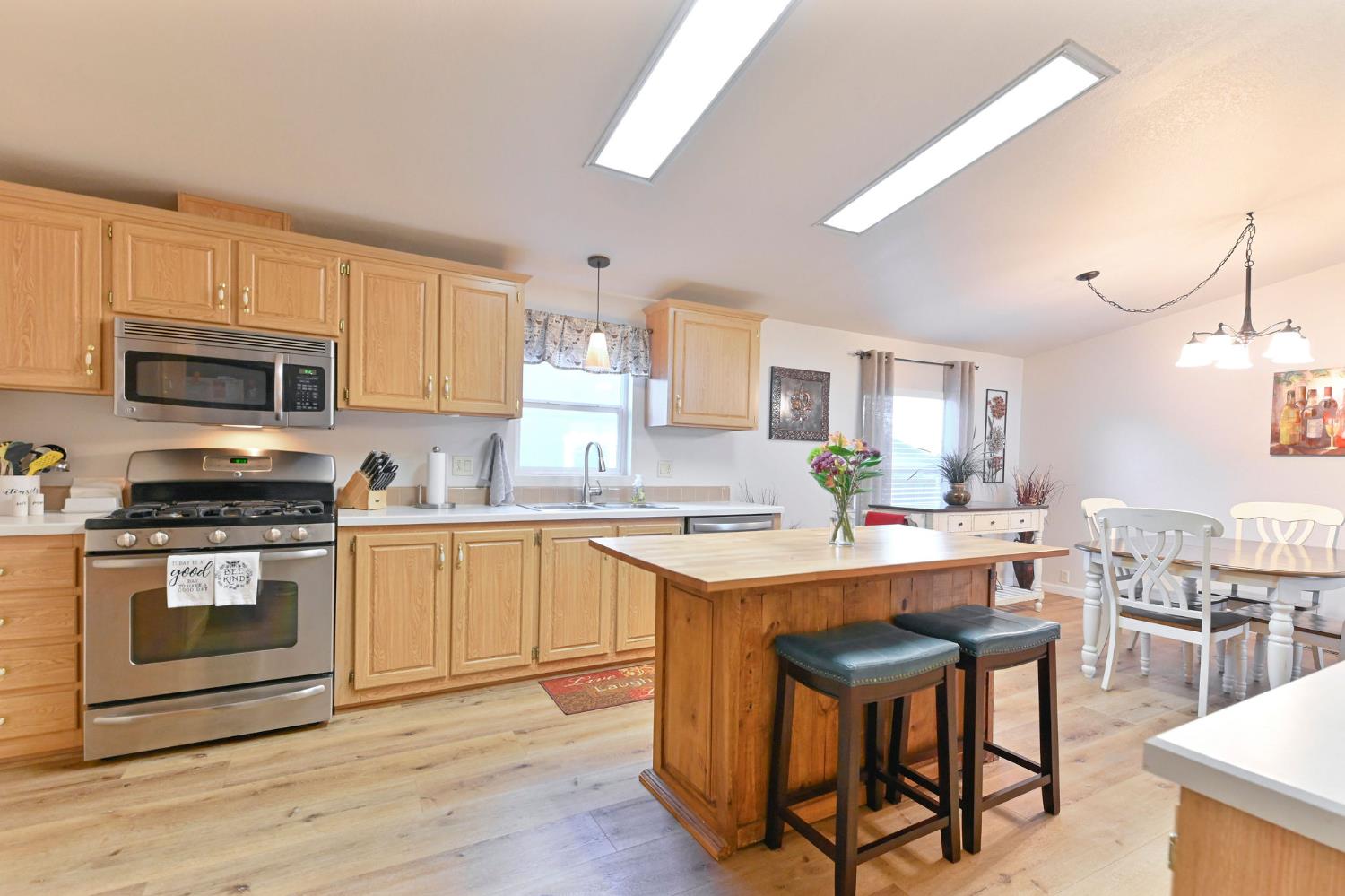 1400 West Marlette Street, Unit 2 Ione, CA 95640 - Photo 22 of 79 a kitchen with stainless steel appliances a stove a sink dishwasher a microwave oven and a refrigerator with wooden floor
