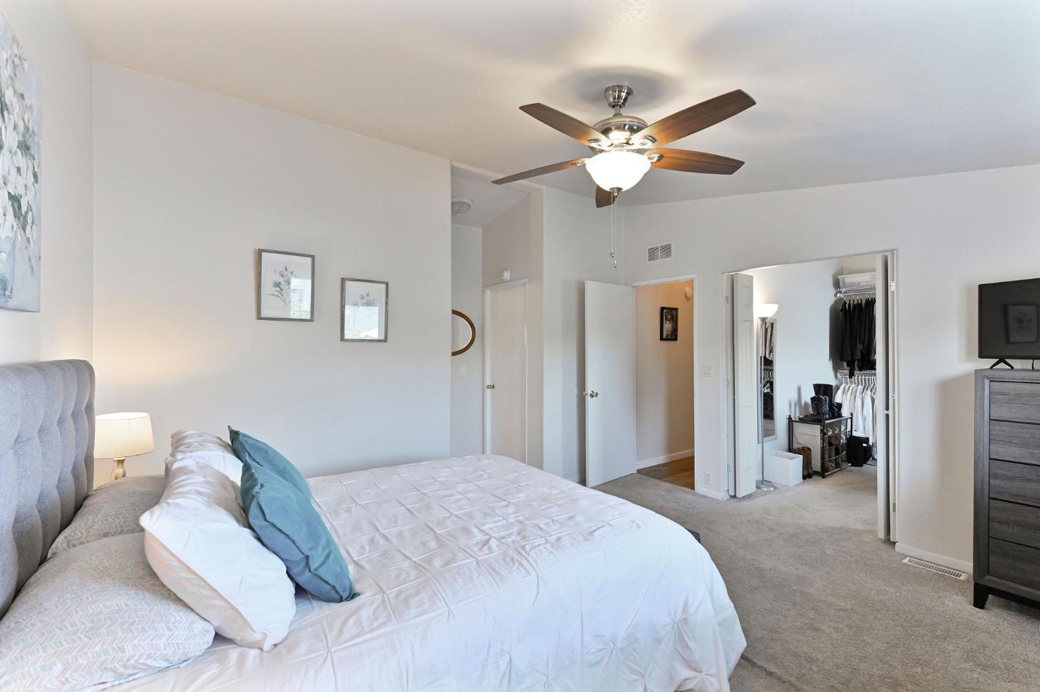1400 West Marlette Street, Unit 2 Ione, CA 95640 - Photo 34 of 79 a bedroom with a large bed and a chandelier