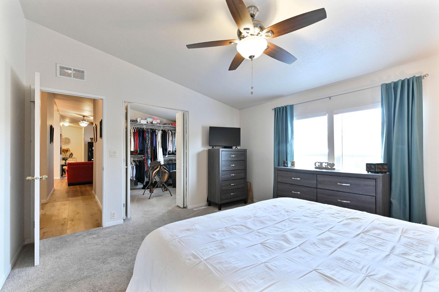 1400 West Marlette Street, Unit 2 Ione, CA 95640 - Photo 35 of 79 a bedroom with a large bed and a chandelier