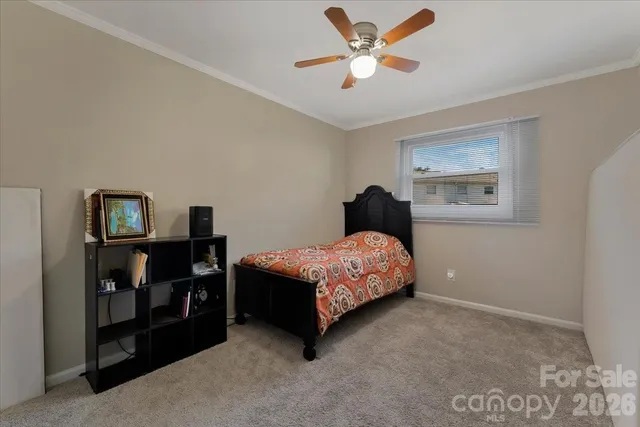 a bedroom with a bed dresser and a window