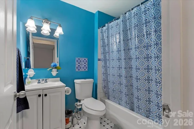 a white toilet sitting next to a bathroom sink