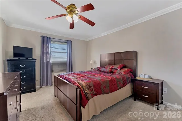 a bedroom with a bed and a tv