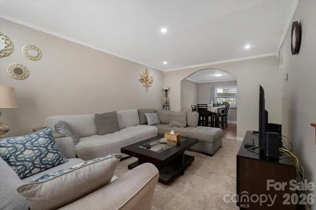 a living room with furniture a rug and a flat screen tv