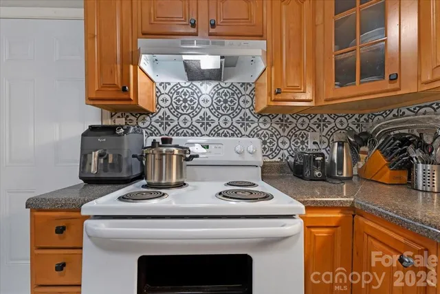 a kitchen with a stove and a microwave