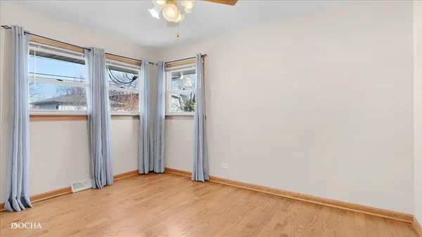 an empty room with windows and closet