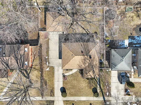 a front view of a house with yard covered in snow