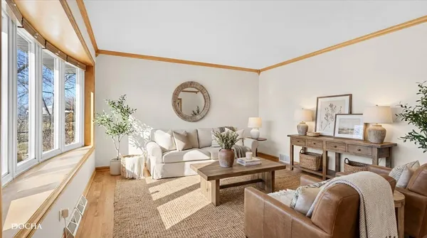a living room with furniture a large window and a clock