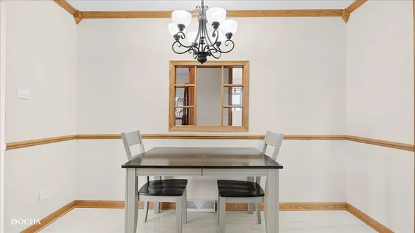 a dining room with a table and chairs