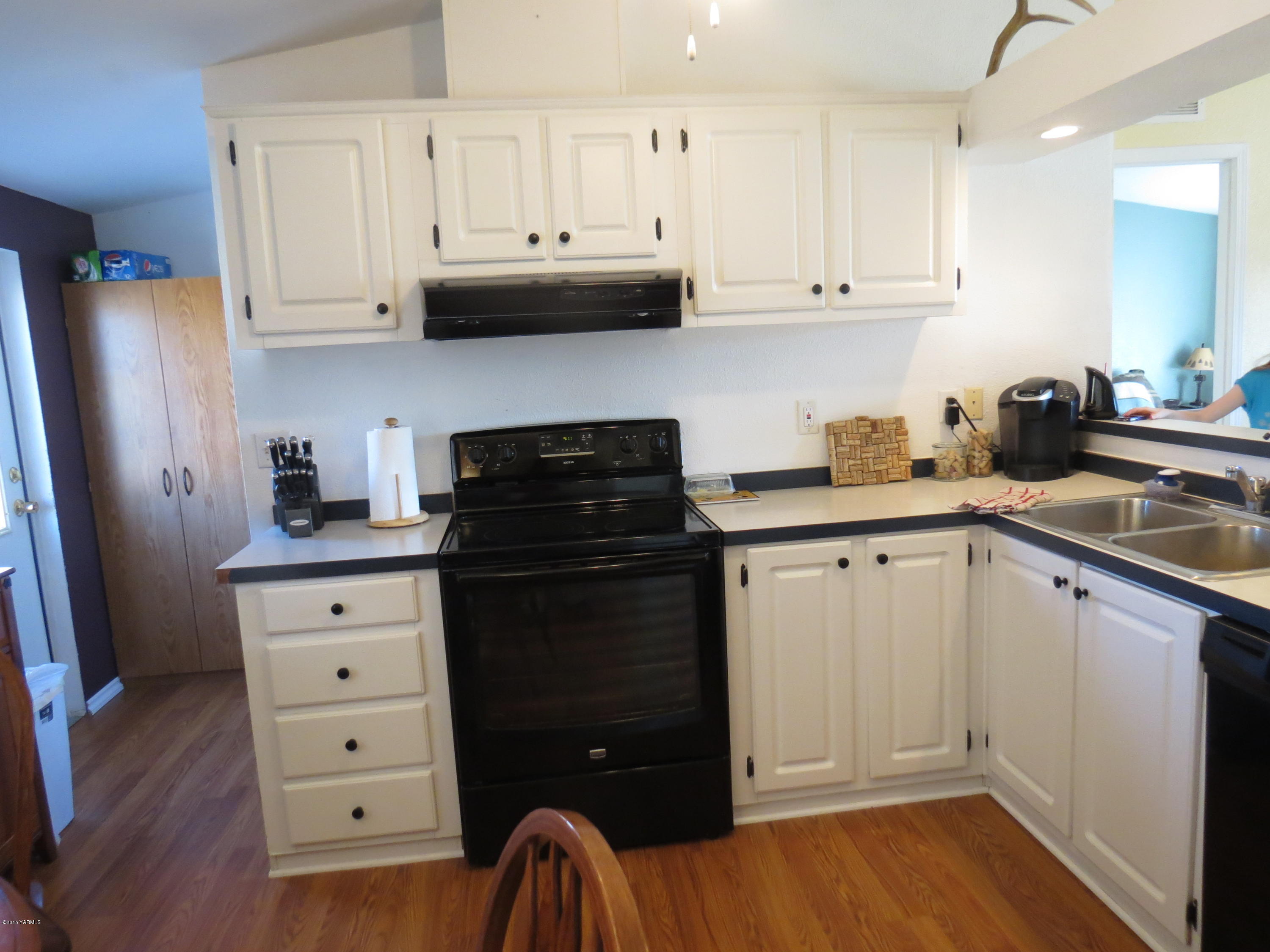 515 Burnham Road Yakima, WA 98908 - Photo 15 of 20 a kitchen with stainless steel appliances granite countertop a refrigerator sink and cabinets