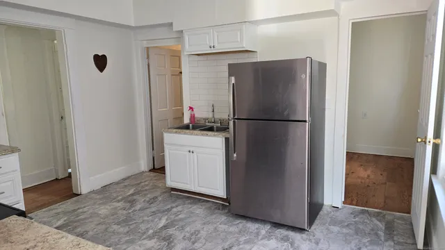 a white refrigerator freezer sitting in a kitchen