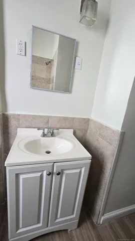 a bathroom with a sink a toilet and a window