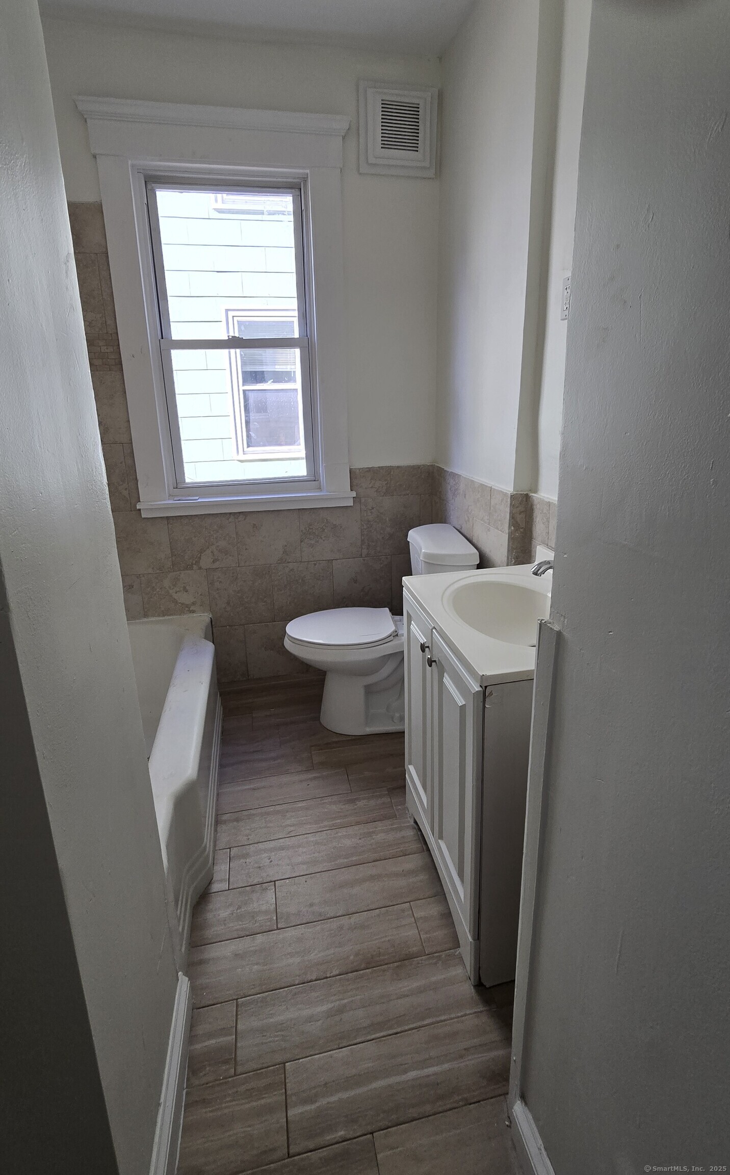 47 Dickerman Street, Unit 1 New Haven, CT 06511 - Photo 6 of 16 a bathroom with a sink a toilet and a window