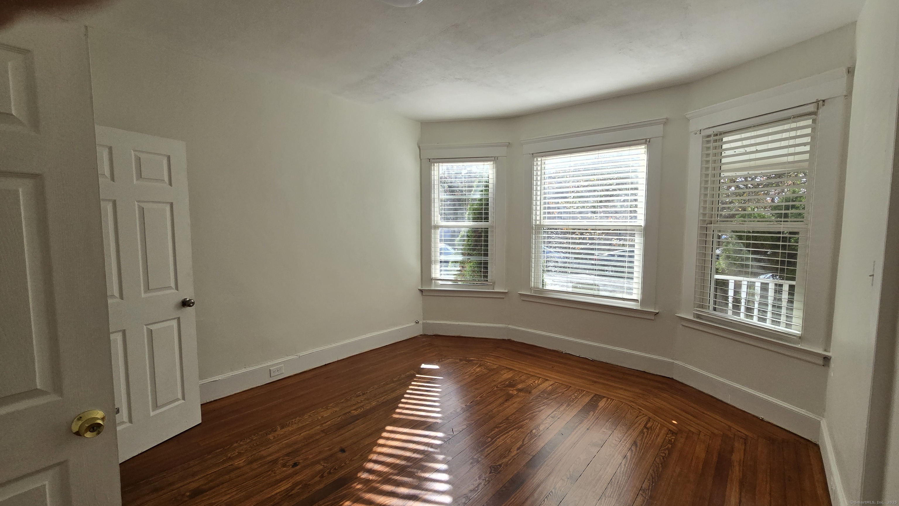 47 Dickerman Street, Unit 1 New Haven, CT 06511 - Photo 9 of 16 a view of an empty room with wooden floor and a window