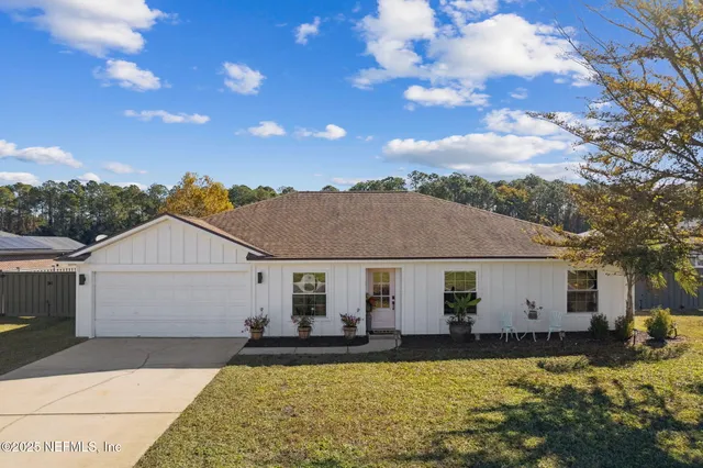 a view of a house with swimming pool and sitting area