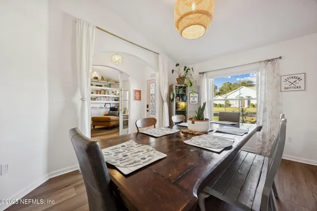 a room with a table chairs and a bed