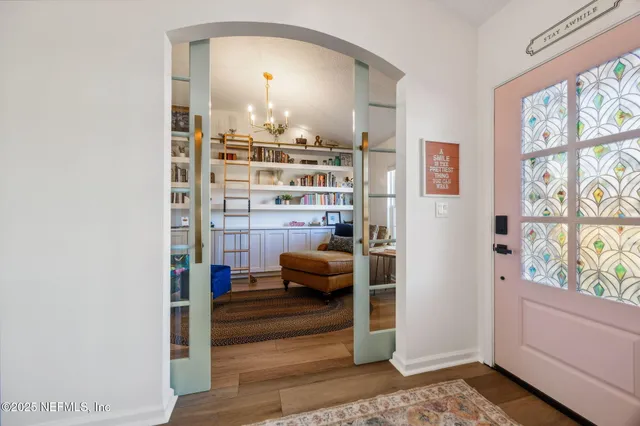 a bedroom with furniture and a large window