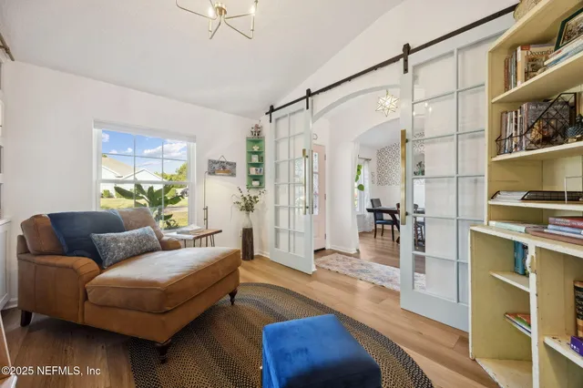 a bedroom with a large bed and a chandelier