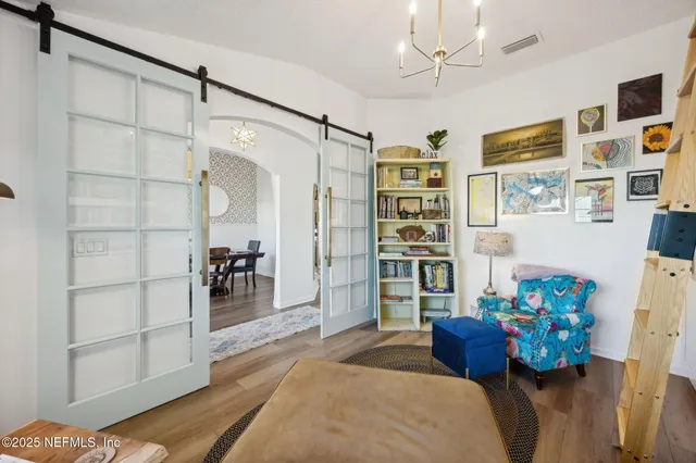 a bedroom with a bed and a chandelier