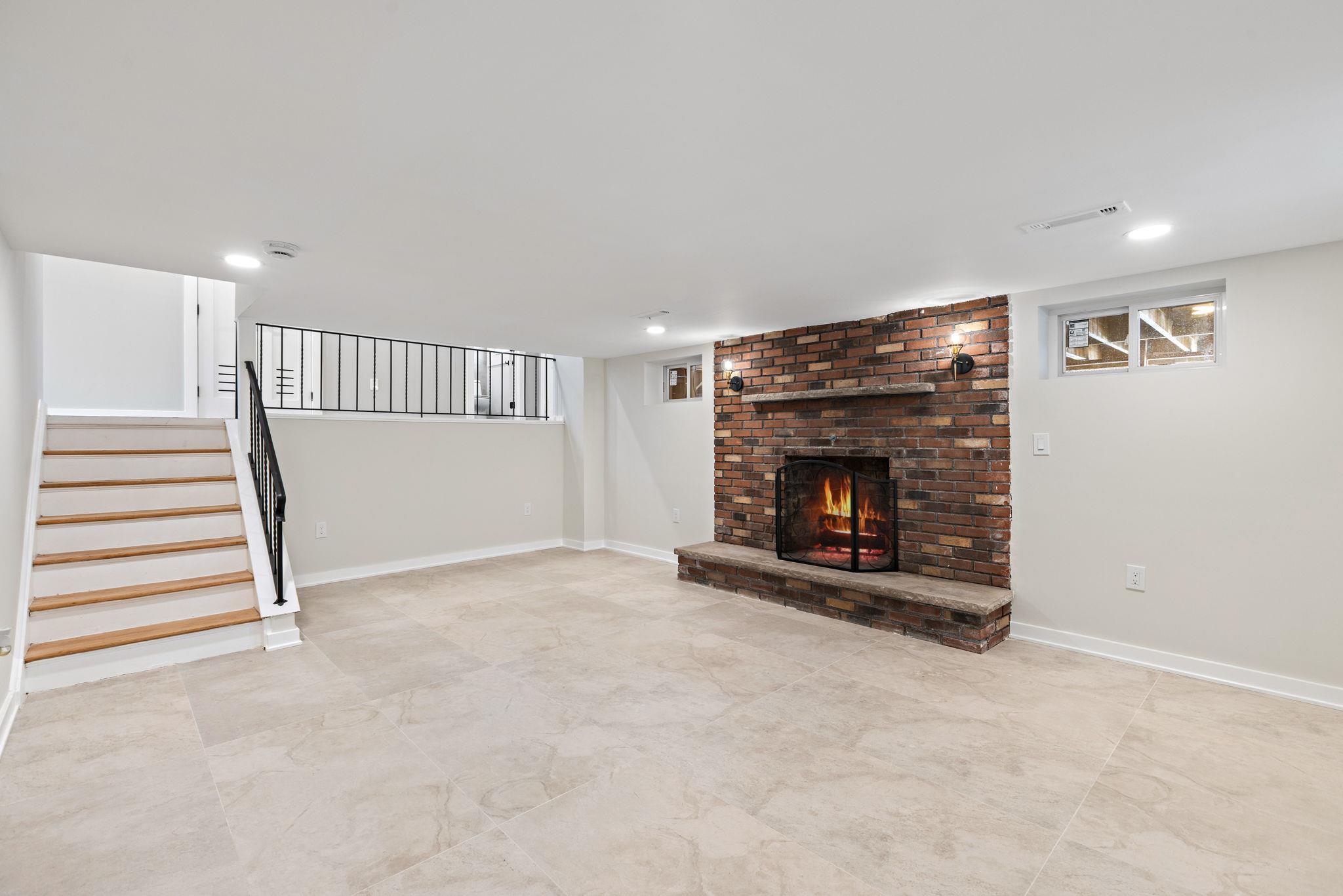 125 Rutgers Place Clifton, NJ 07013 - Photo 17 of 36 a view of a livingroom with a fireplace stairs and windows