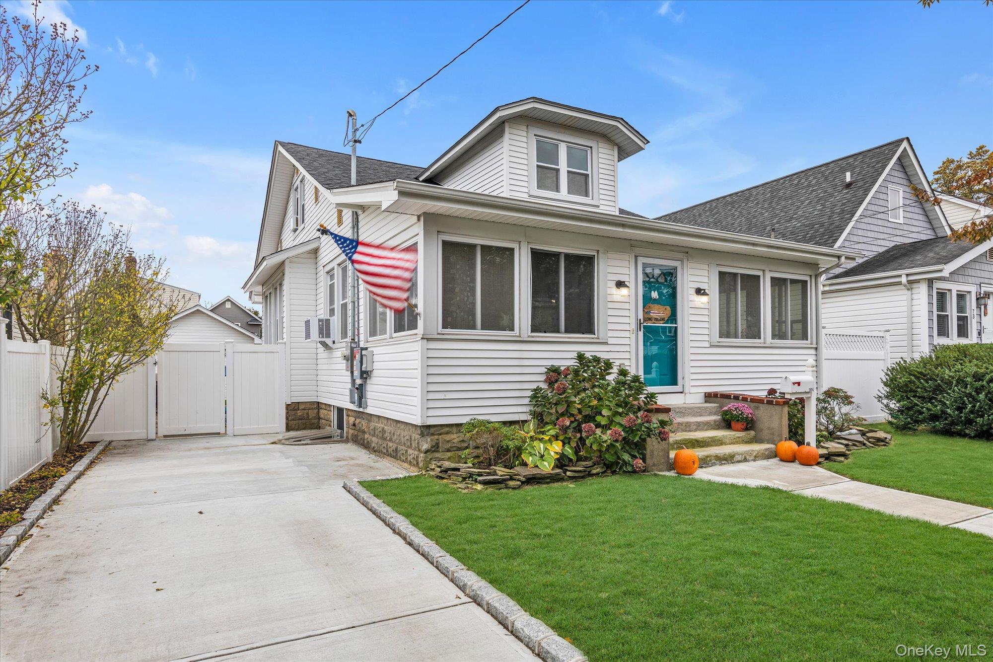 1894 Commonwealth Avenue Merrick, NY 11566 - Photo 2 of 22 a front view of a house with a yard