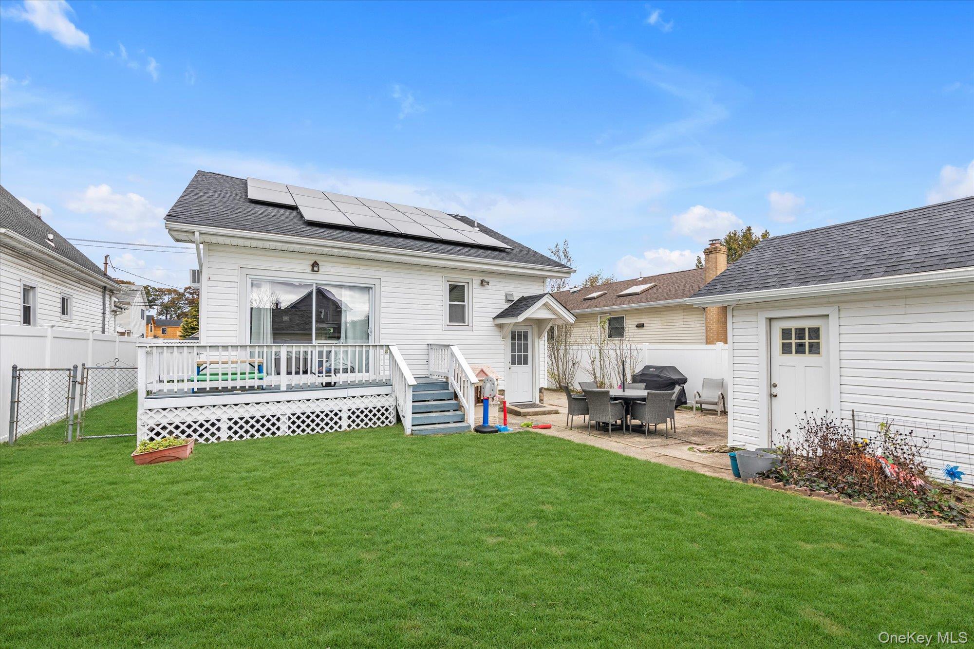 1894 Commonwealth Avenue Merrick, NY 11566 - Photo 21 of 22 a front view of a house with a yard garden and patio