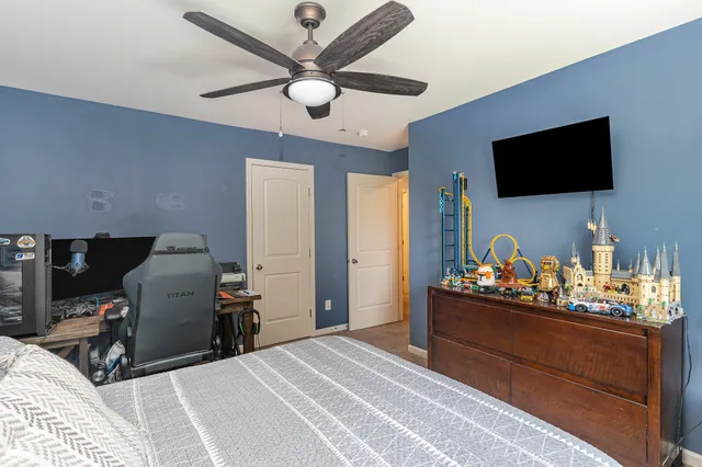 a bedroom with a bed and flat screen tv